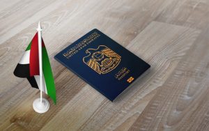 Dubai passport and Dubai Flag on a table.