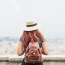 Woman with backpack overlooking city view