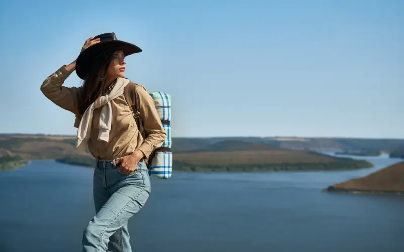 Solo traveler with hat and backpack